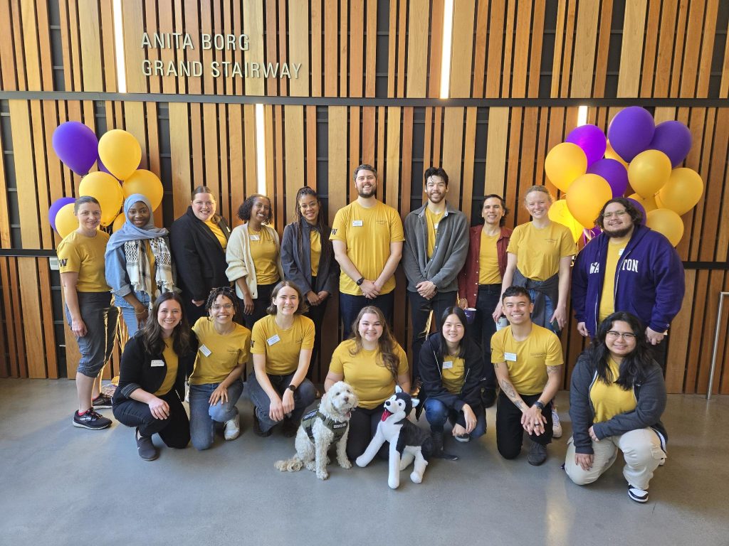 The undergraduate student services team posing for a grop photo wearing UW purple and gold.